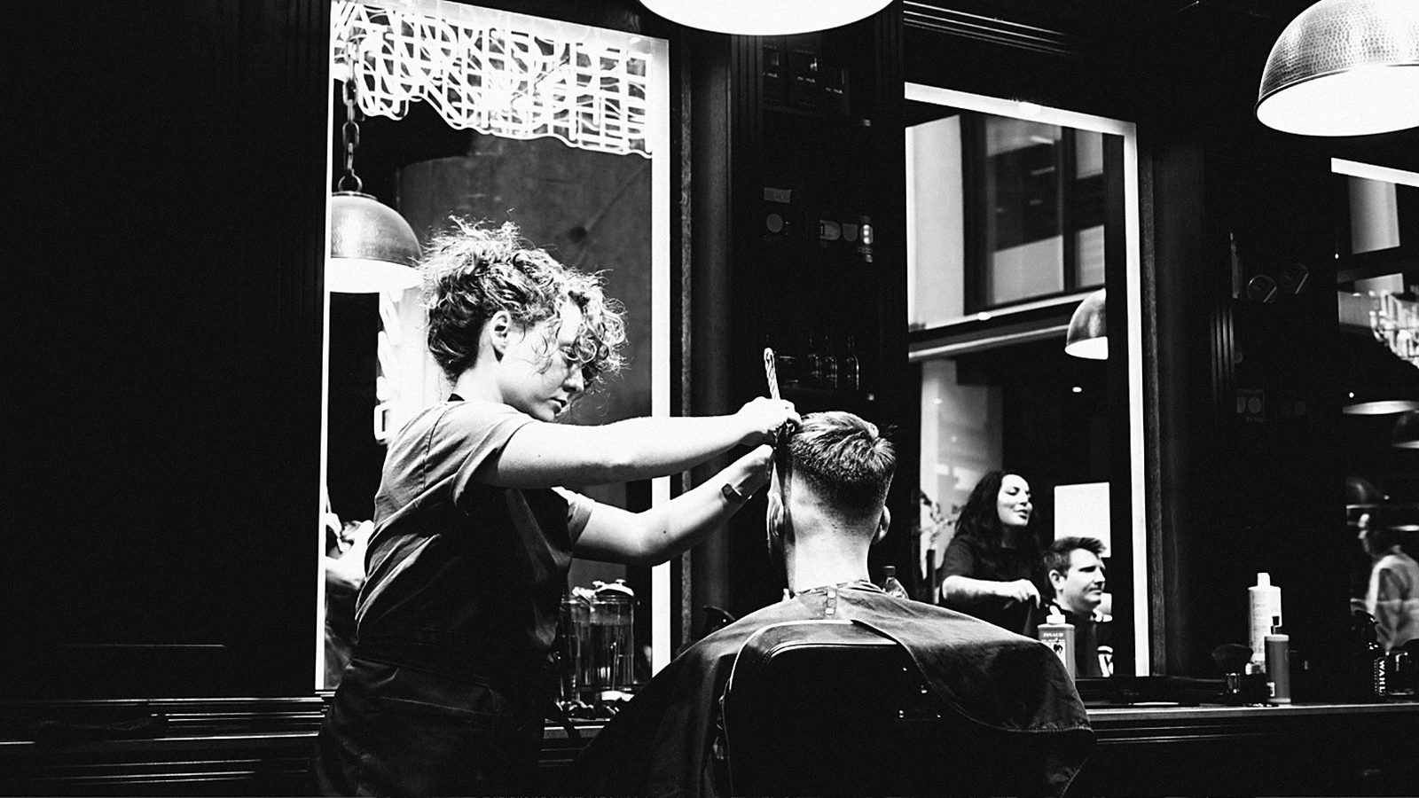 A Sydney Barbers barber cutting a client's hair at the chair